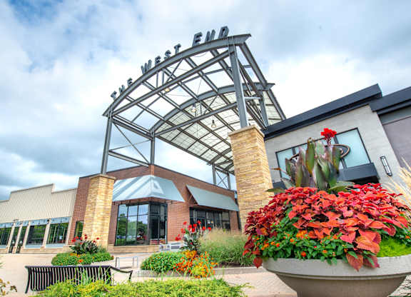 the exterior of a building with plants and flowers