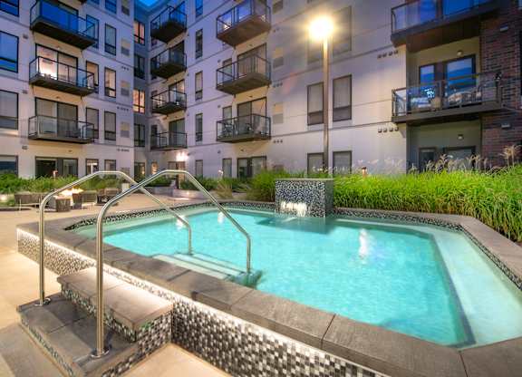 a swimming pool in front of an apartment building
