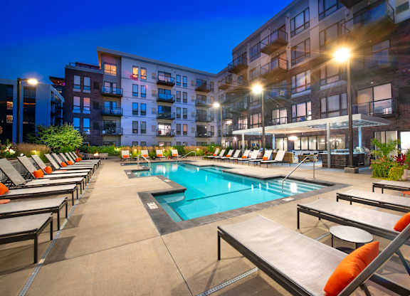 a swimming pool at night at an apartment building