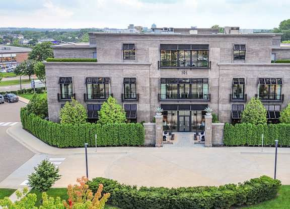 an aerial view of a building with a courtyard and trees