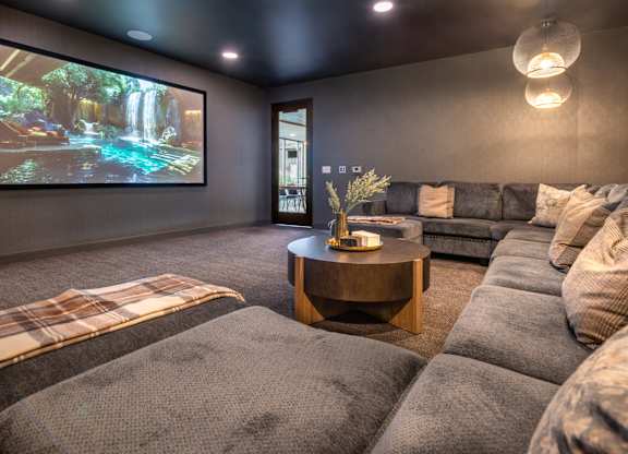 a living room with couches and a tv on the wall