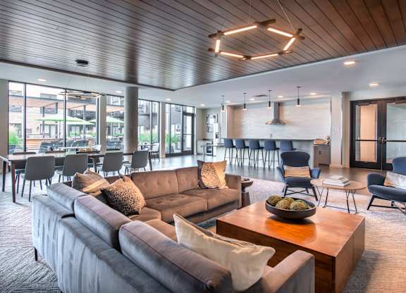 a living room with couches and chairs and a table