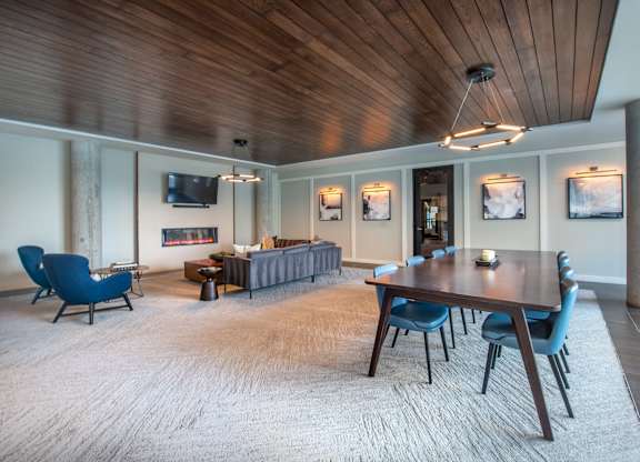 a conference room with a long wooden table and blue chairs