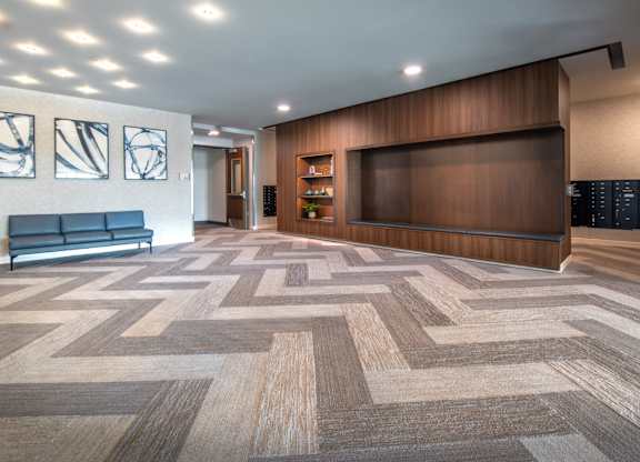 a lobby with a checkered floor and a large wooden wall and a television