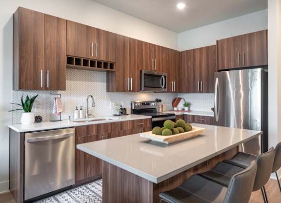 a kitchen with stainless steel appliances and a white counter top