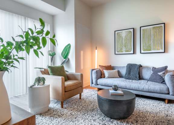 a living room with a gray couch and a coffee table