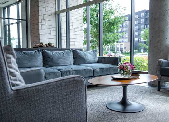 a living room with a couch and a table with flowers