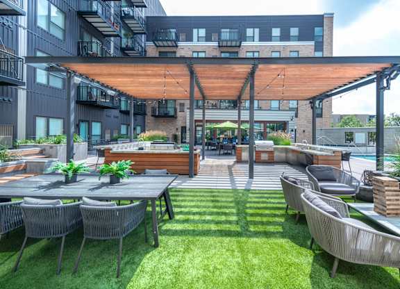 a patio with tables and chairs and a glass roof