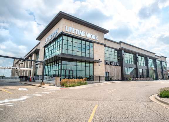 a life time work building with a street in front of it