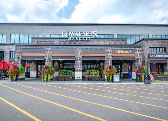 a building with a sign on it in front of a parking lot