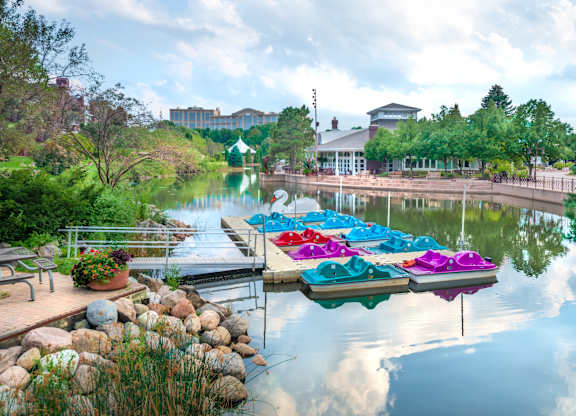 a row of colorful boats parked on the water at a dock