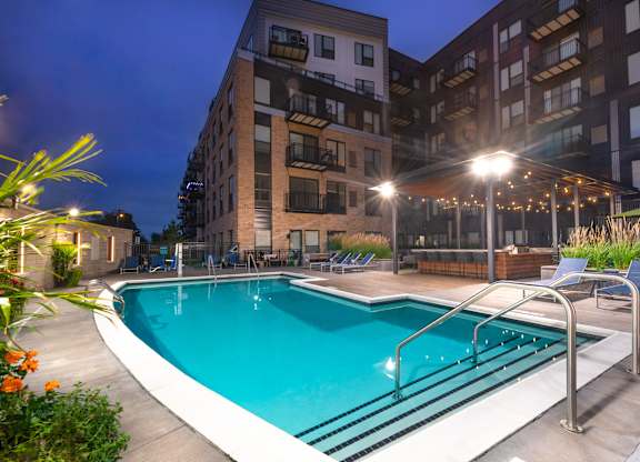 the swimming pool at night at the grove apartments