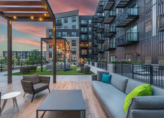 a rendering of an apartment lobby with couches and a table