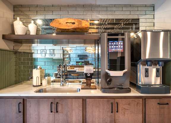 a kitchen with a coffee machine and a sink