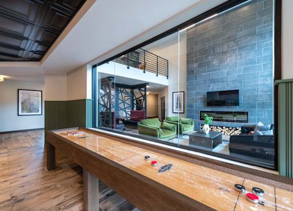 a large mirror in a living room with a pool table