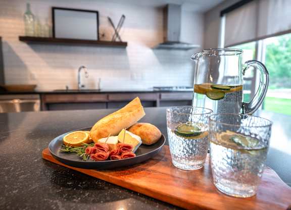 a table with a plate of food and a glass of water on it