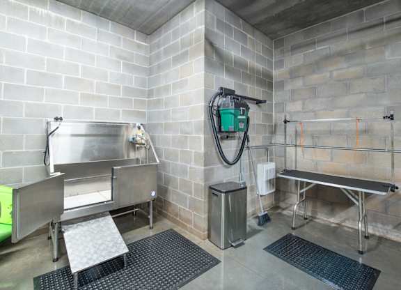 a wet room with a shower and a sink in a public restroom