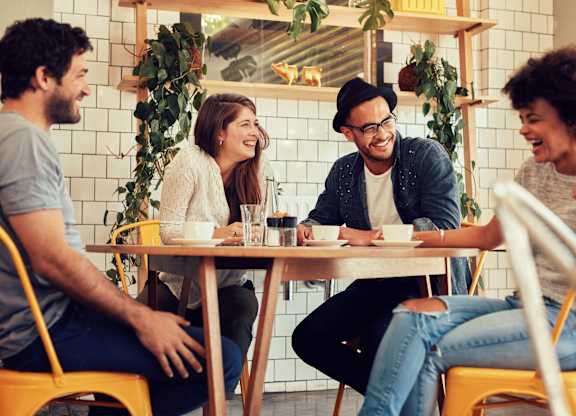 a group of people sitting at a table in a restaurant