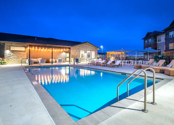 the swimming pool at night at the resort at governors crossing