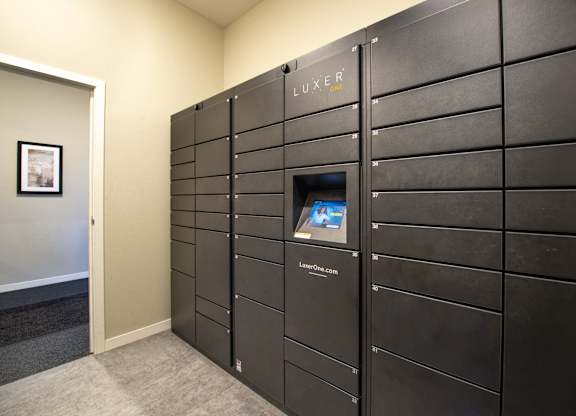 a large set of lockers in a room with a screen on the door