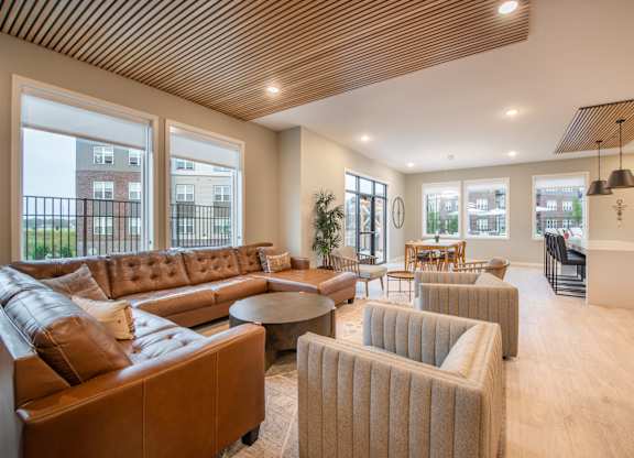 a large living room with couches and chairs and a table