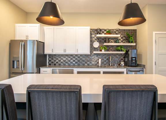 a kitchen with white cabinets and a white counter top