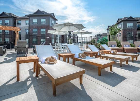 an outdoor patio with tables and chairs and umbrellas