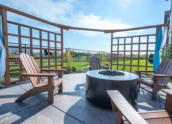 an outdoor seating area with benches and a geometric design on a patio