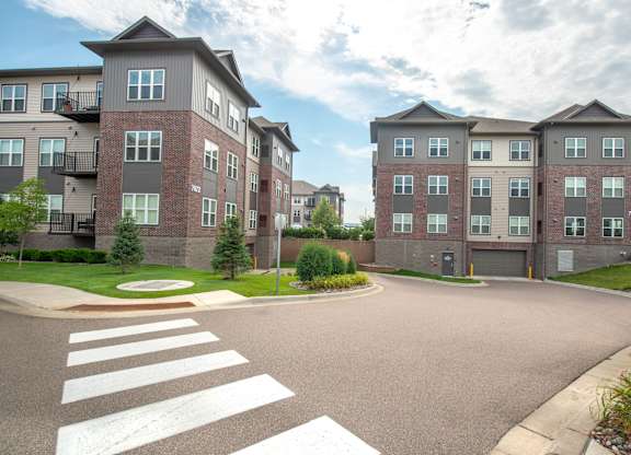 an empty street with an apartment building in the background