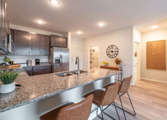 a kitchen with a granite counter top and stainless steel appliances
