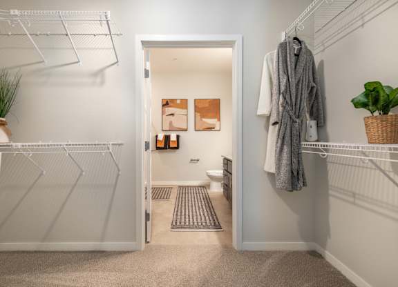 a bathroom with a closet and a shower and a toilet