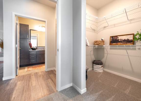 a bathroom with a toilet and a sink in a room with a doorway