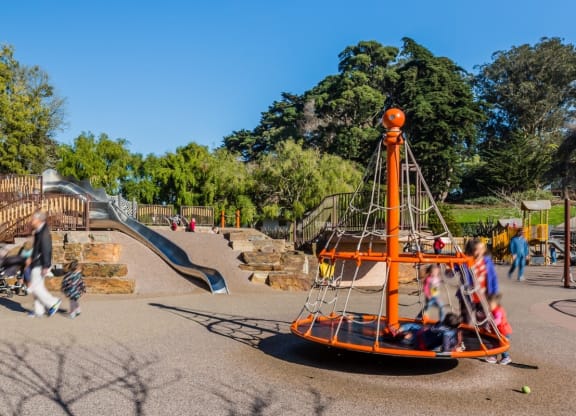 a playground with a swing set and a slide