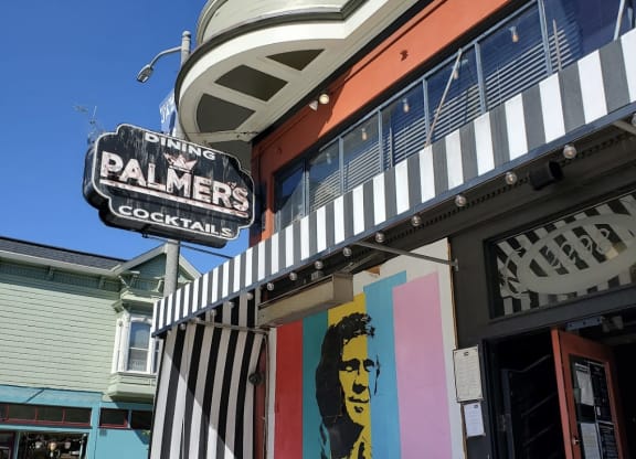 a restaurant with a mural of a woman on the front of it