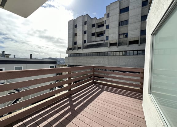 a view from a balcony of a building with a blue sky in the background