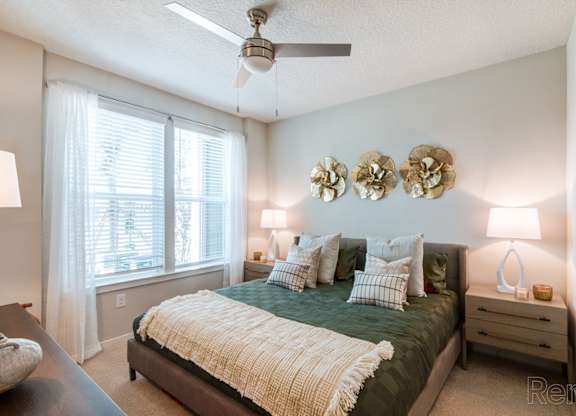 A bedroom with a ceiling fan, and a window with blinds at Tapestry Nona in Orlando, FL
