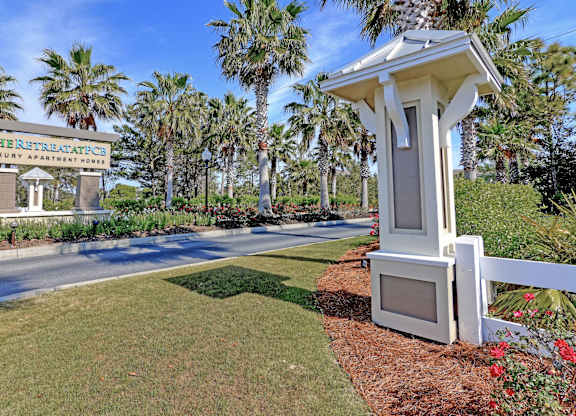 A sign for The Retreat Apartments is visible in the image.