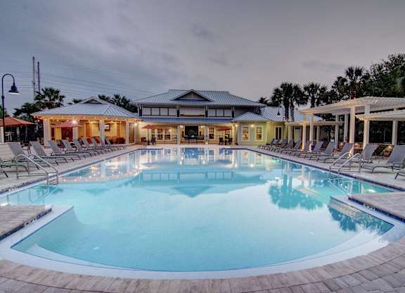 A large outdoor swimming pool with a building in the background.