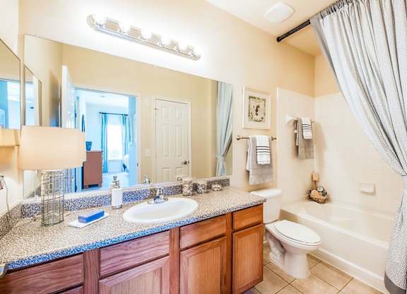 A bathroom with a sink, toilet, and bathtub.