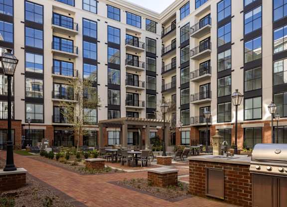 Gas grilling area and courtyard with seating at 2020 Providence in Huntsville, AL