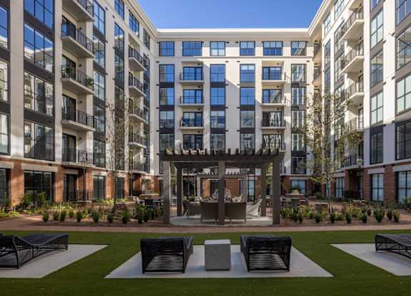 Modern mid-rise building with courtyard and social area at 2020 Providence in Huntsville, AL