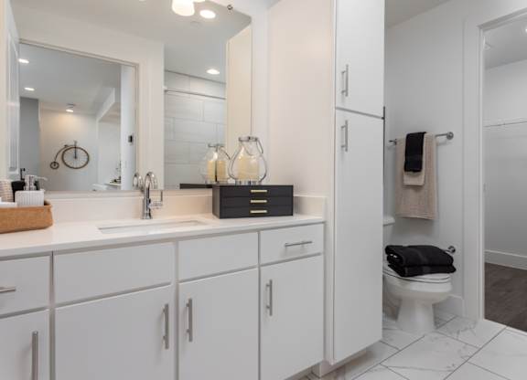 Modern bathroom with wood floors and attached walk-in closet at 2020 Providence in Huntsville, AL