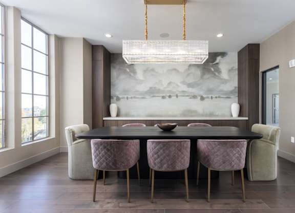 Clubhouse conference room with wood plank flooring, modern light fixture, and floor-to-ceiling windows. at 2020 Providence in Huntsville, AL
