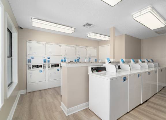 A laundry room with washers and dryers.