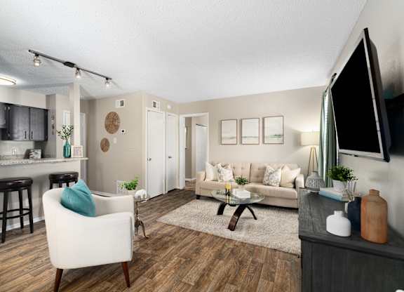 A living room with a white chair and a brown coffee table.