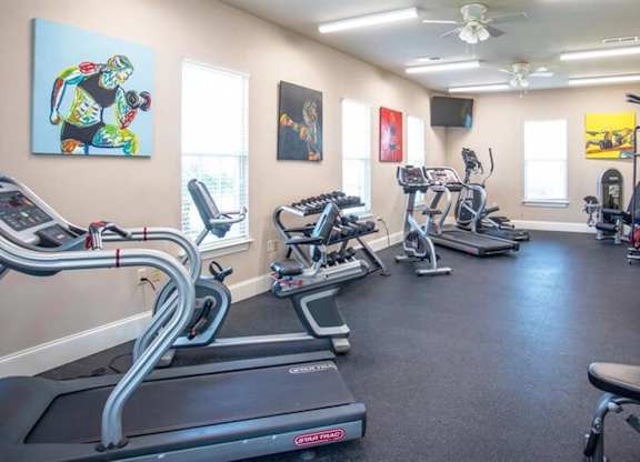 a gym with cardio machines and other exercise equipment