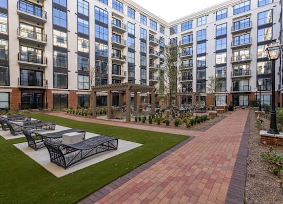 A courtyard with pergola, grilling station, and seating at 2020 Providence in Huntsville, AL.