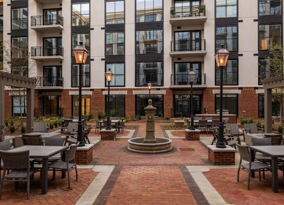 A courtyard with tables and chairs at 2020 Providence in Huntsville, AL.