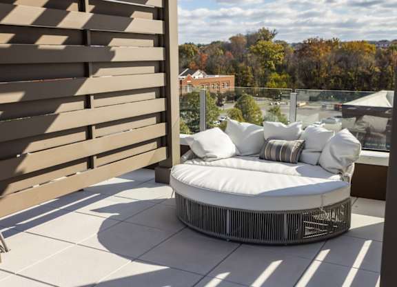Rooftop, poolside cabana with white lounge chairs at 2020 Providence in Huntsville, AL