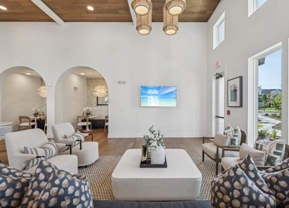 A living room with a television and a large window.